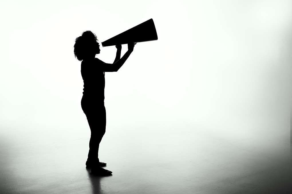 silhouette of woman holding rectangular board